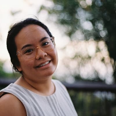 A smiling client wearing glasses, photographed outdoors