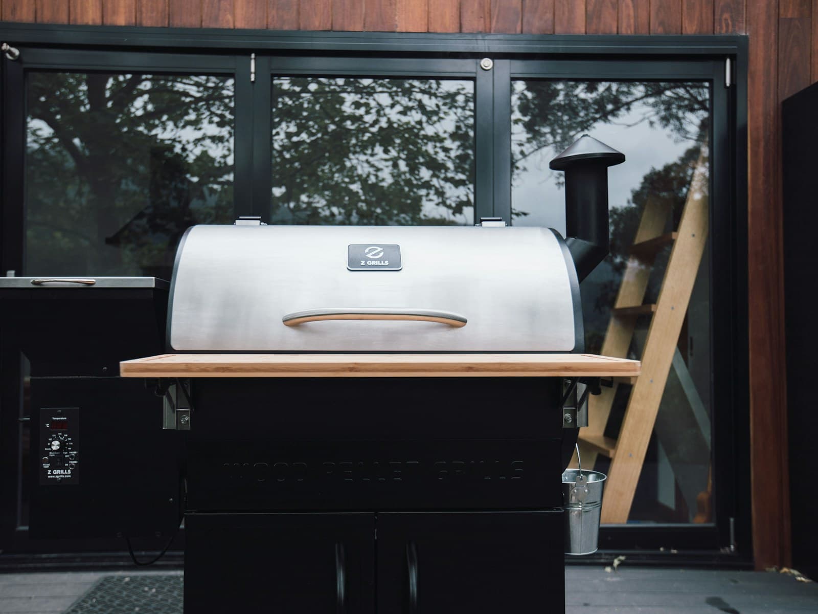 A built-in outdoor grill in a garden kitchen