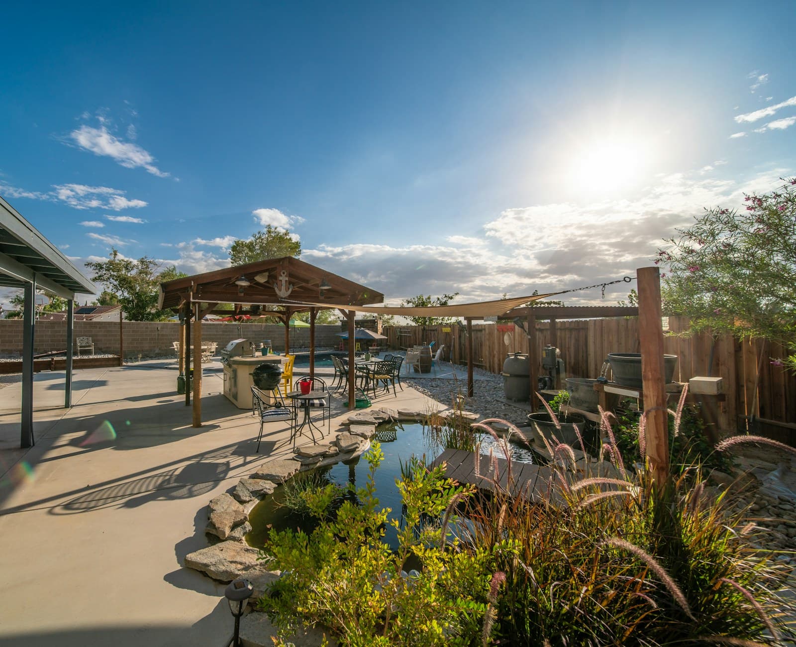 A backyard with a small ornamental pond and a gazebo