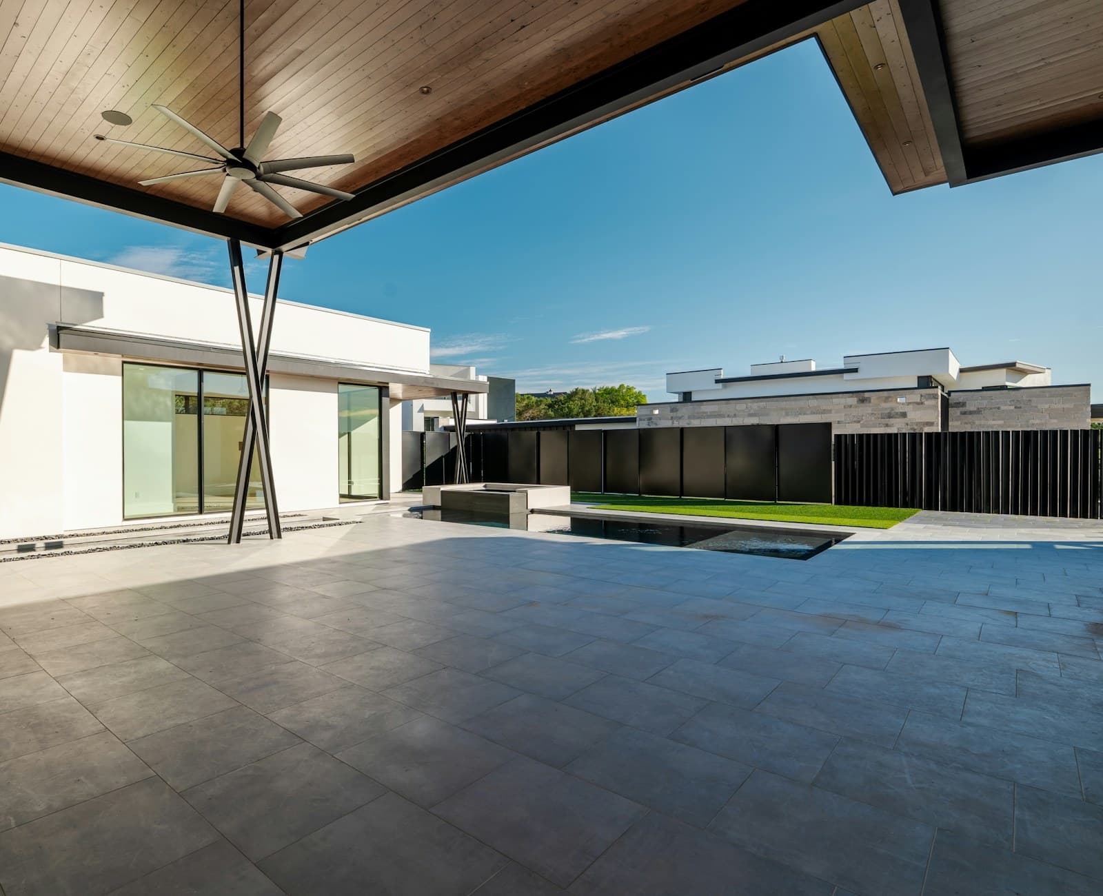 A modern patio and pool set against contemporary architecture