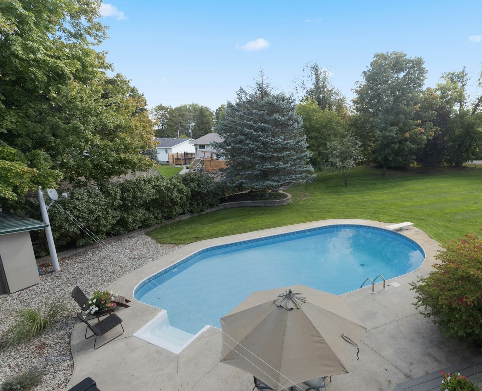 Aerial view of a backyard swimming pool and surrounding terrace