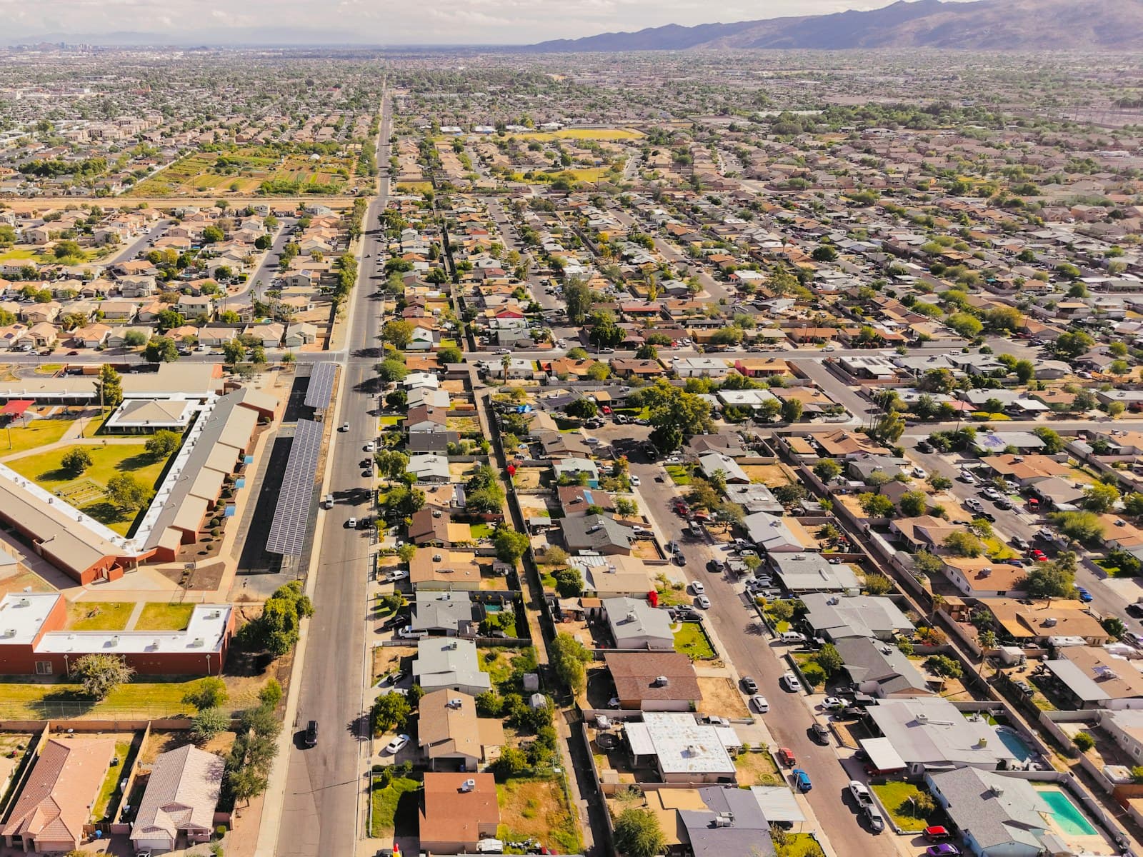 Aerial view over a suburban neighbourhood of houses and green gardens