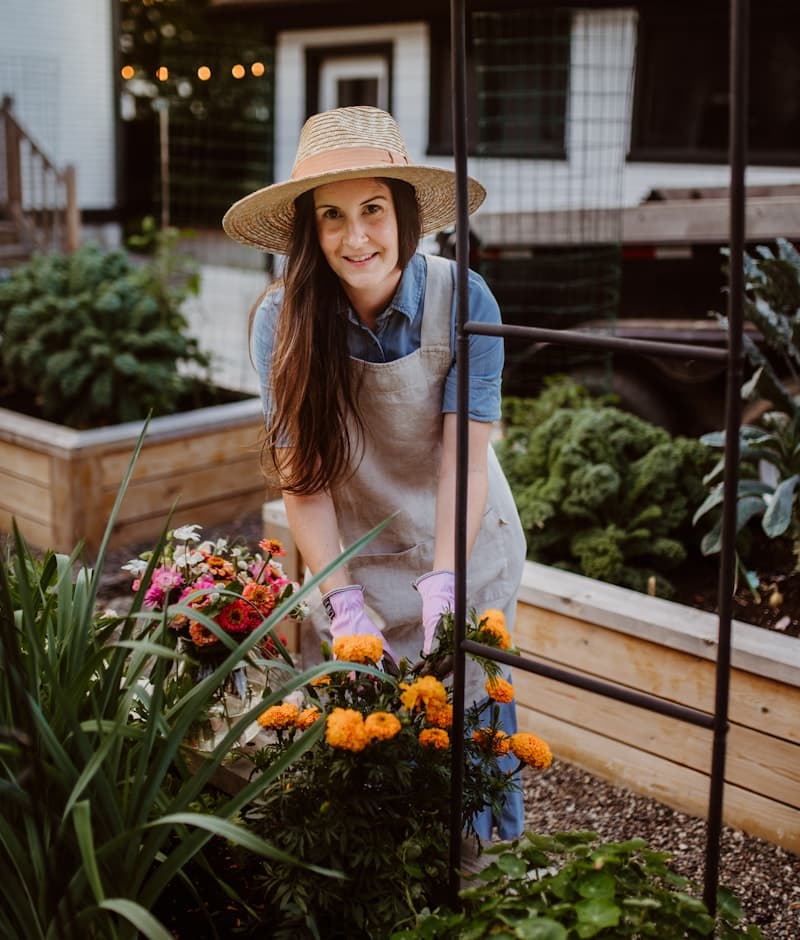 A member of the Verdora team in a sun hat and gardening gloves