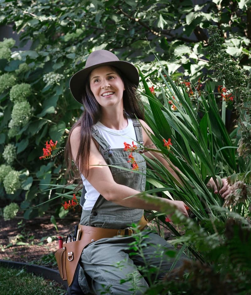 A member of the Verdora team seated in a planted garden